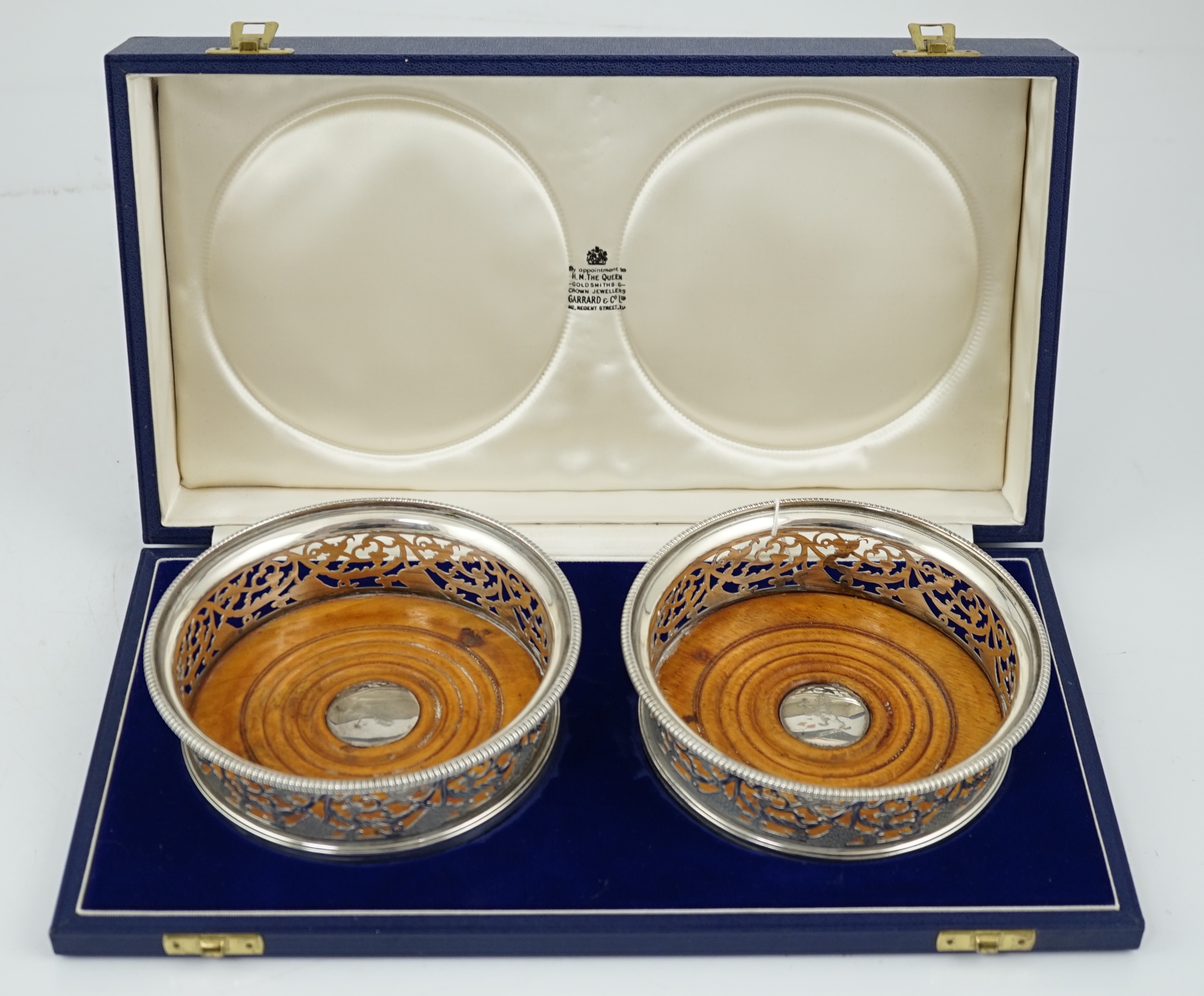 A pair of George III pierced silver mounted wine coasters, William Allen III